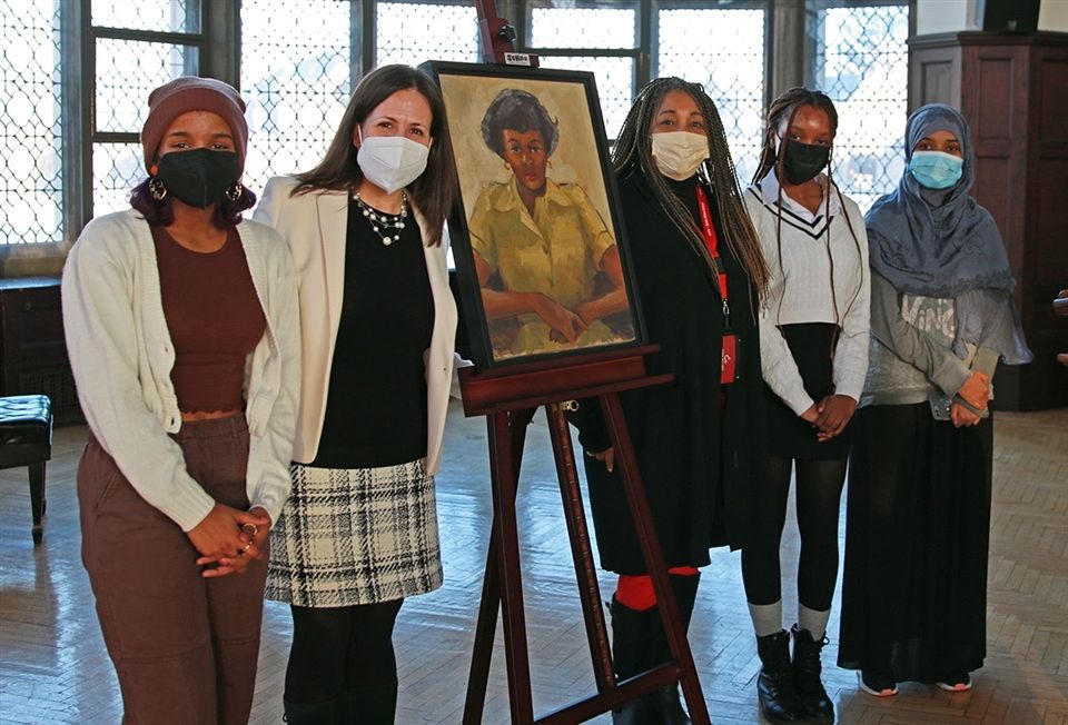 Left to right: Ashauna, Ms. Rao, Ms. Gilmore, Kirsten, and Narmene pose with the portrait following the ceremony