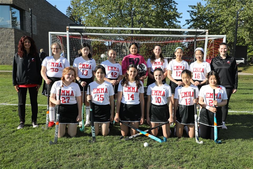 Coco and Nini Y. ’25 with their JV Field Hockey teammates and coaches